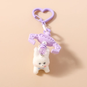 Detail of creative plush puppy keychain featuring purple heart hook and metal claw charm