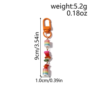 Detail of colorful beaded keychain with rainbow cylinder beads and orange clasp