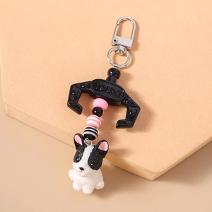 Detail showing cartoon French Bulldog keychain with metal hook, beads and resin doll