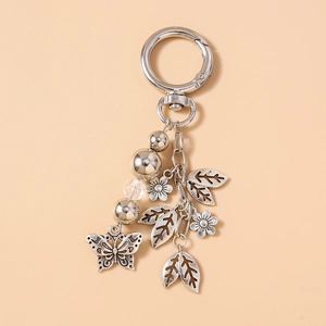 Macro shot of vintage silver keychain with butterfly, flower charms and beaded accents