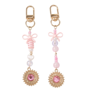 Porte-clés perles roses avec nœud et pendentif soleil strassé en métal doré