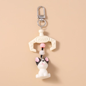 Detail of French Bulldog keychain with striped beads and unique cream claw clip accessory