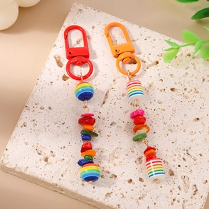 Colorful striped beaded keychain with vibrant turquoise stones and a metal clasp