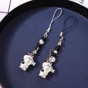 Chic beaded cat phone charm with white kitten pendant and heart beads on tray