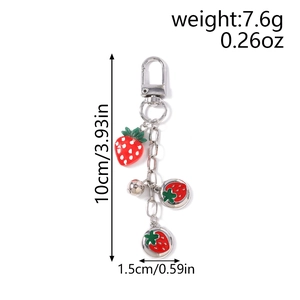 Detail showing strawberry keychain dimensions: 10cm height and 7.6g weight on white background