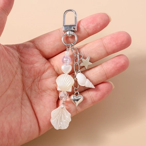 Detail of ocean-themed keychain with shell, starfish, heart charms and beads