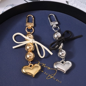 Portachiavi a cuore con perline e fiocco in camoscio in finiture oro e argento