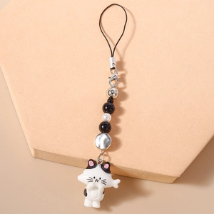 Detail of beaded phone strap featuring a cute black and white cat pendant and pearls