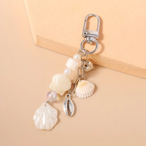 Detailed view of marine shell keychain with starfishes, pearls and silver lobster clasp