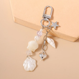 Detail of beaded ocean keychain with silver metal lobster clasp and seashell charms