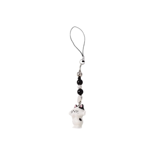 Fashionable beaded phone charm featuring a cute white cat pendant with black spots