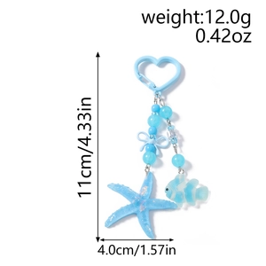 Detail view of ocean-themed keychain with blue beads, starfish charm, and fish pendant