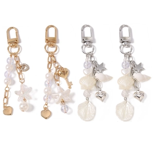Ocean-themed keychain set with pearls, starfish, and heart charms in gold and silver