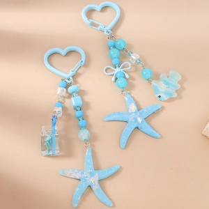 Ocean themed keychain with blue starfishes, fish charms and beads on heart hook