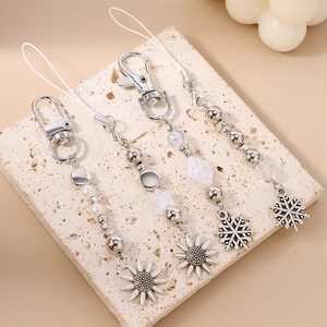 Bijoux de téléphone et porte-clés perlés tendance avec motifs tournesol et flocons
