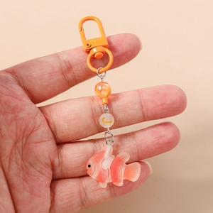 Detail of beaded keychain featuring a resin clownfish pendant and orange round beads