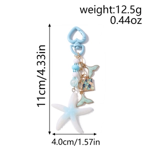 Detail view of ocean-themed keychain with starfish, fish tail charms and size dimensions