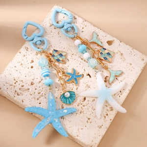 Nautical heart keychain set with sea star shell and striped beads on white stone background