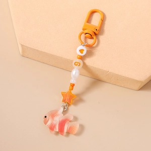 Detail showing orange heart, star beads, and clownfish pendant on a beaded keychain charm