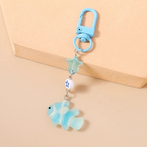 Detail of light blue ocean-themed keychain with beads, star, and gradient fish pendant