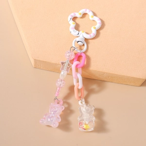 Detail of colorful acrylic bear keychain with floral clasp and pastel beaded chain