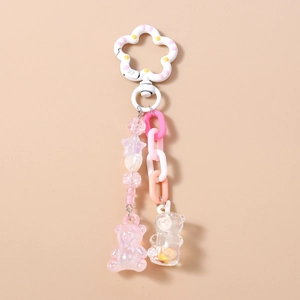 Cute pink beaded bear keychain with white flower clip and sequin bear charm detail