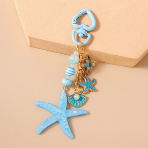 Detailed view of ocean theme keychain with blue starfish, shell pearls and heart clasp