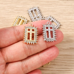 Rectangular cross pendant with rhinestones and white pearls in gold and silver finish