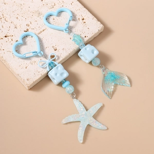 Light blue starfish and fish tail keychains with heart carabiners and resin beads