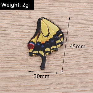 Macro shot of 45mm yellow butterfly charm pendant for DIY jewelry showing exact dimensions