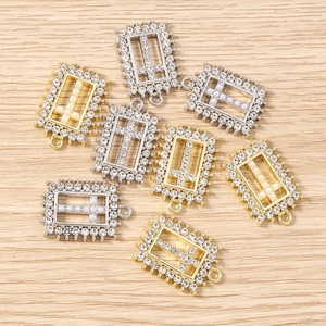 Close-up of geometric cross charms with rhinestones and pearls for DIY jewelry making