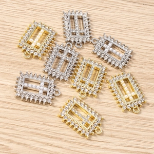 Detailed close-up of rectangle cross pendants with pearls and rhinestones for DIY jewelry