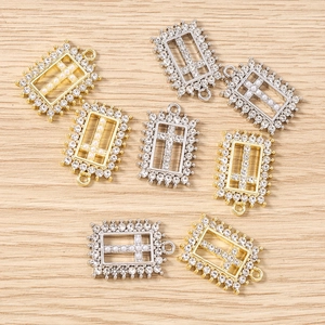 Macro shot of rectangular cross pendants with rhinestones and pearls for DIY jewelry