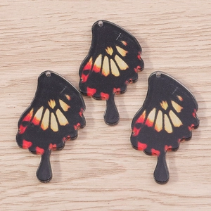Three acrylic butterfly wing charms with red and yellow gradient for DIY jewelry making