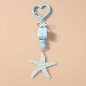 Detail of blue starfish pendant keychain with glitter resin star and heart clip