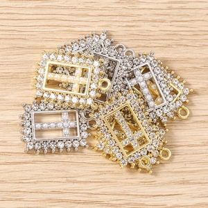 Detail of cross charms with pearls and rhinestones for DIY jewelry making