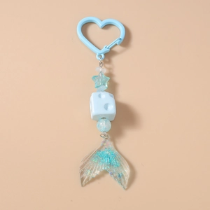 Detailed view of sea-inspired keychain with blue heart ring, fish tail, and glitter star