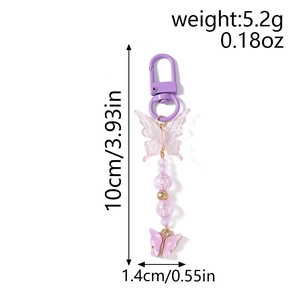 Detail view of butterfly keychain with purple beads and dimensions 10cm x 1.4cm