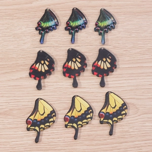 Macro shot of colorful acrylic butterfly wing charms for DIY jewelry and earrings