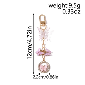 Detail view of butterfly keychain measurements showing 12cm length and purple beads