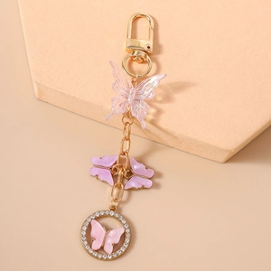 Detail of pink beaded butterfly keychain with rhinestone ring and gold metal clip