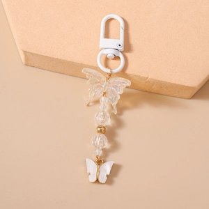 Detail of beaded butterfly keychain with white frosted clasp and iridescent butterfly charm