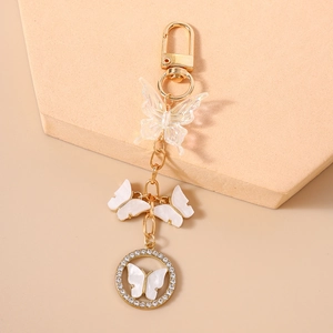 Close-up of golden butterfly keychain with crystal rhinestones and beaded resin charms