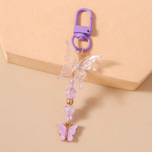 Detail of purple butterfly keychain with acrylic beads and iridescent butterfly pendant