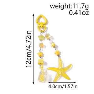 Detail view of yellow starfish keychain with beaded star and heart carabiner, 12cm length