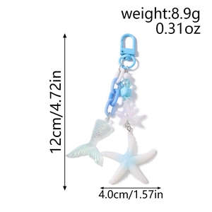 Detail of beaded keychain with blue sea star and pearlescent mermaid tail charms