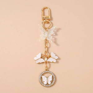 Detail of golden butterfly keychain featuring crystal rhinestones and beaded butterfly charms