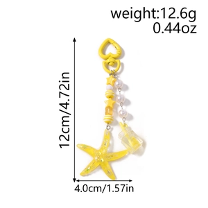 Detailed view of yellow starfish keychain with drink charm and heart clasp, 12cm length