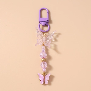 Detail of beaded butterfly keychain featuring purple metal clasp and acrylic charms