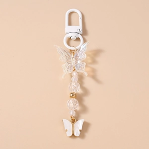 Detail of beaded butterfly keychain featuring iridescent charms and a white lobster clasp